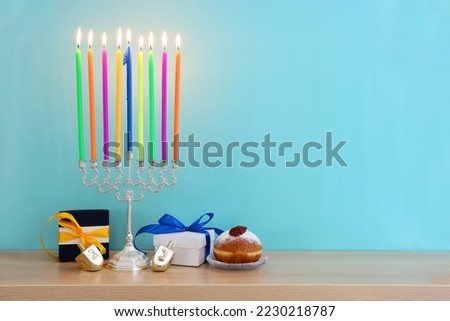 image of jewish holiday Hanukkah background of spinning tops with letters that mean, A GREAT MIRACLE HAPPENED HERE 