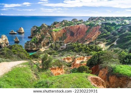 wooden tourist footbridges on the cliffs of Cabo de Sao Vicente. View of beaches, cliffs and ocean. Daylight, horizontal Royalty-Free Stock Photo #2230223931