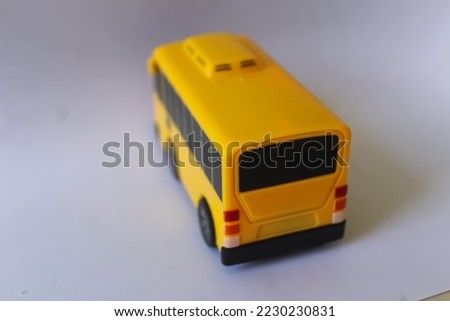 children's toy in the form of a yellow bus miniature