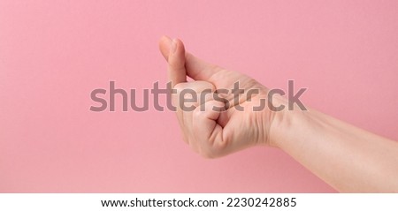 finger heart. Zoomers symbolize love. woman hand showing heart sign on pink background.