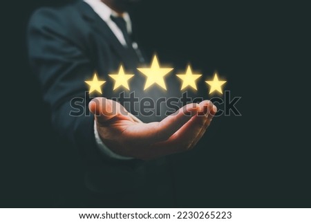 Customer evaluation feedback. men in suit Giving Positive Review for Client's Satisfaction Surveys. giving a five star rating. Service rating, satisfaction concept. Royalty-Free Stock Photo #2230265223