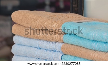 Colorful towels stacks closeup picture. A stack of terry towels in the street shop. Different pastel colors, selected focus. Turkey (Turkiye). Home design or household concept