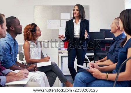 This is how we can distinguish ourselves from our competitors.... Shot of a group of office workers in a meeting. Royalty-Free Stock Photo #2230288125