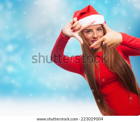 portrait of a beautiful young woman at Christmas doing a photo gesture