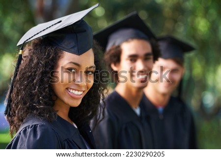 Bright young grads. Portrait of a diverse group of students on graduation day. Royalty-Free Stock Photo #2230290205