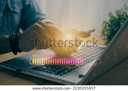 Casual Businessman Touching Mobile Phone or Smart Phone and Yellow Magenta Stick Loading Bar and Laptop Computer. Searching or Downloading Concept in Vintage Tone Royalty-Free Stock Photo #2230295837
