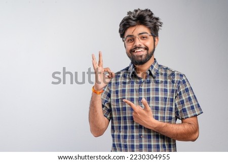 Young Indian businessman against white background