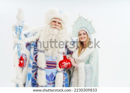actors in a traditional Father Frost and Snow Maiden costume on a white background. traditional family celebration. congratulations and concert for children. carnival. Father Christmas. Russia.