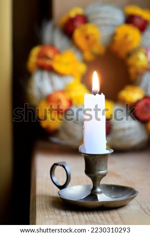 A candle on vintage candle holder. Wooden background. Royalty-Free Stock Photo #2230310293
