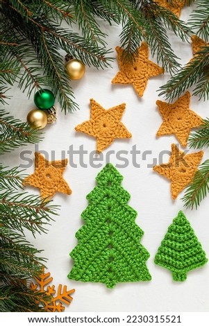 Festive Christmas composition with crochet green Christmas tree and yellow stars. Handmade Christmas craft ideas.
