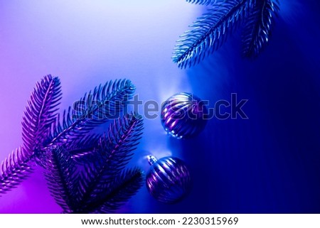 Christmas layout with christmas tree branches, christmas decorations in vibrant neon glow. copy space. top view. flat lay