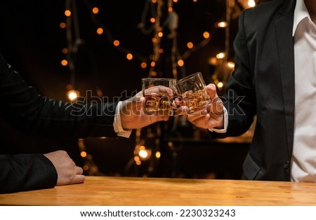 Celebrate whiskey on a friendly party in  restaurant Royalty-Free Stock Photo #2230323243