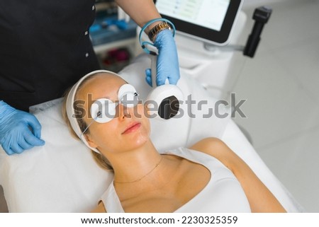medium closeup view of a Caucasian woman undergoing non surgical face lifting at the cosmetology center, facial treatment. High quality photo