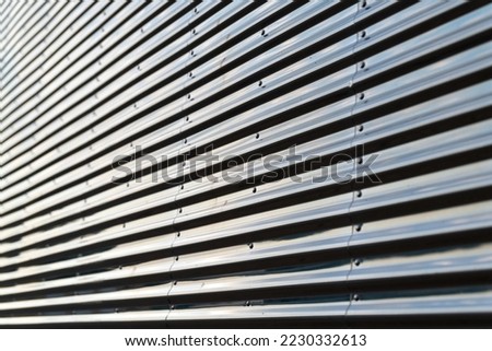 Gray corrugated metal wall up close, abstract, background in Minnesota, USA.
