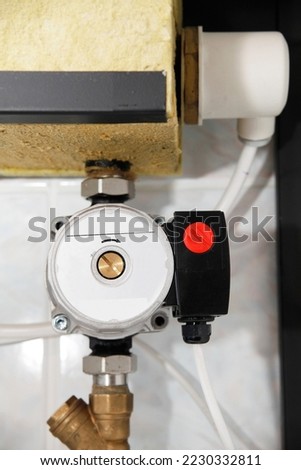 Hot Water Recirculation Pump Repair. Close up on hot water recirculation pump inside electric boiler. Royalty-Free Stock Photo #2230332811