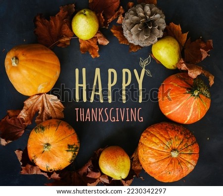 Happy Thanksgiving text with pumpkins and leaves over wood background