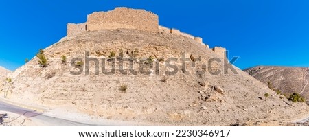 A view looking up at the ruins of the crusader castle and surrounding countryside in Shobak, Jordan in summertime