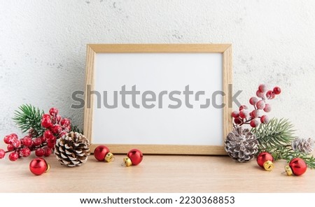 White blank wooden frame mockup with Christmas decorations  on the wooden table.  Frame for quotes. Christmas postcard.
