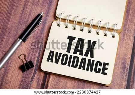 Taxes Avoidance. Text on business notebook with pen