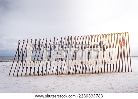 Liepaja city title at Baltic beach. Big letters. Royalty-Free Stock Photo #2230393763