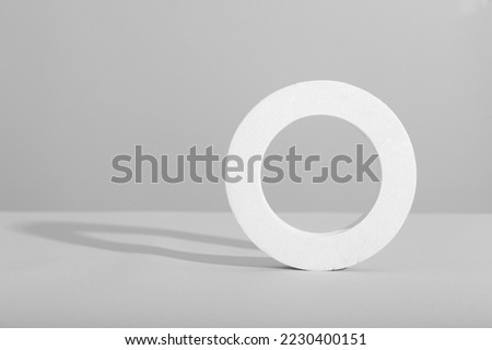 white podium on a white background with harsh light