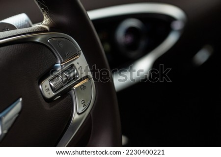 Cruise control switch closeup. Adaptive cruise control leaver. Cruise control on steering wheel. Royalty-Free Stock Photo #2230400221