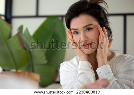 beautiful woman applying skin care therapy
