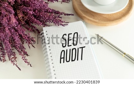 On a white background notepads, paper clips, pencils and the inscription - SEO AUDIT