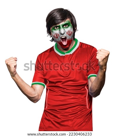 Soccer fan man with jersey and face painted with the flag of the IR IRAN team screaming with emotion on white background. Royalty-Free Stock Photo #2230406233