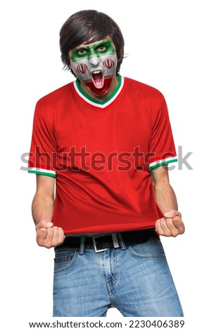 Soccer fan man with jersey and face painted with the flag of the IR IRAN team screaming with emotion on white background. Royalty-Free Stock Photo #2230406389