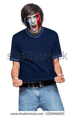 Soccer fan man with jersey and face painted with the flag of the France team screaming with emotion on white background.