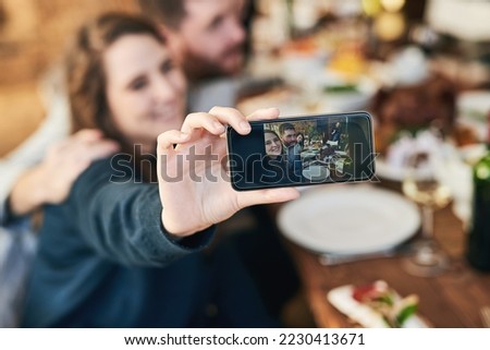 Couple, family lunch and phone selfie in home at dinner table for thanksgiving celebration memory. Festive fine dining, love and man and woman take picture with mobile smartphone for social media.