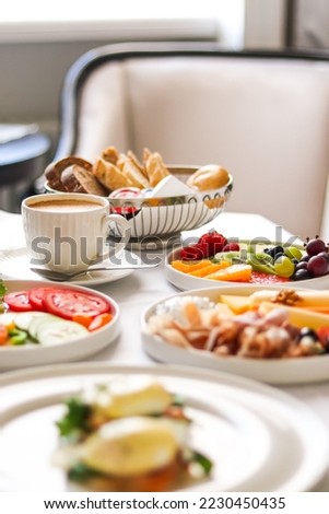 Luxury hotel and five star room service, various food platters, bread and coffee as in-room breakfast for travel and hospitality brand Royalty-Free Stock Photo #2230450435