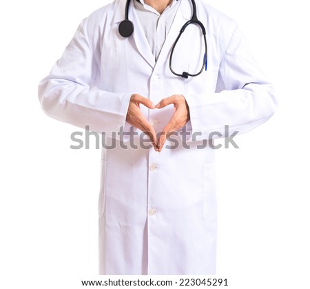 Doctor making a heart with her hands over white background