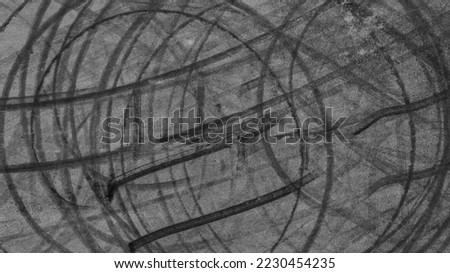 Aerial view tire track mark on asphalt tarmac road race track texture and background, Abstract background black tire track skid on asphalt road, Tire mark skid mark on asphalt road. Royalty-Free Stock Photo #2230454235