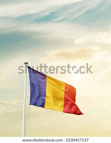 Romania national flag waving in beautiful sky.
