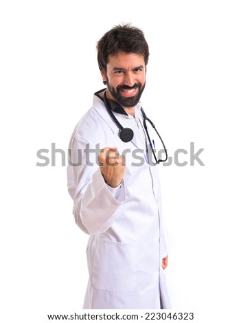 Lucky doctor over isolated white background
