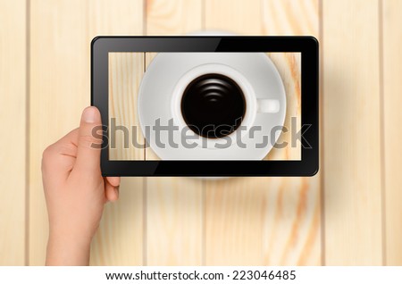 Waves like Wi-fi sign in cup of coffee with tablet PC