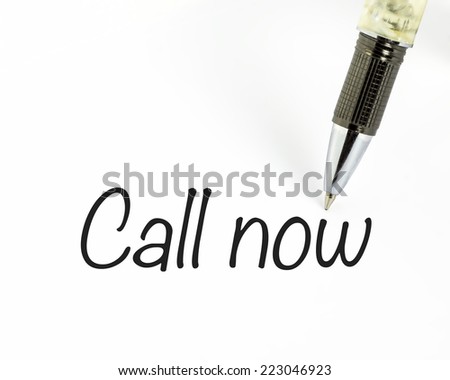 Pen writes call now word on paper
