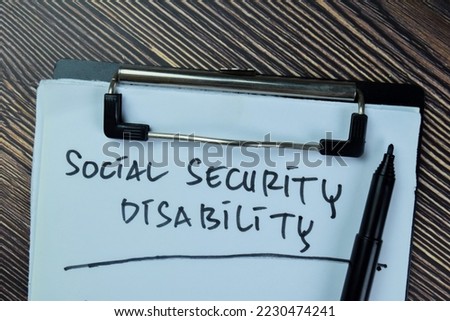 Concept of Social Security Disability write on paperwork isolated on Wooden Table. Selective focus on social security disability text