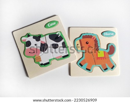 educational toys horse and cow puzzle made of wood on white background 