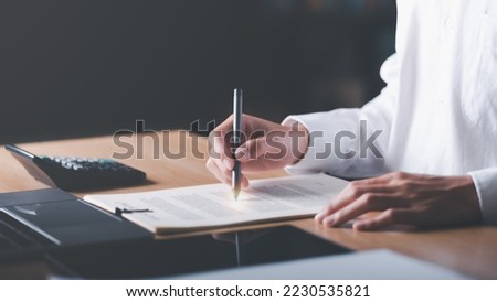 Businessman Audit documents, quality assessment management With a checklist, business document evaluation process, market data report analysis and consulting, plan review process. Royalty-Free Stock Photo #2230535821