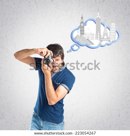Man photographing over grey background