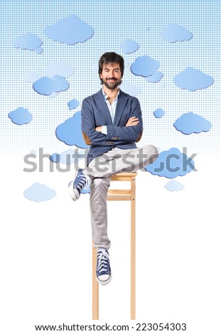 Businessman with his arms crossed over sky background