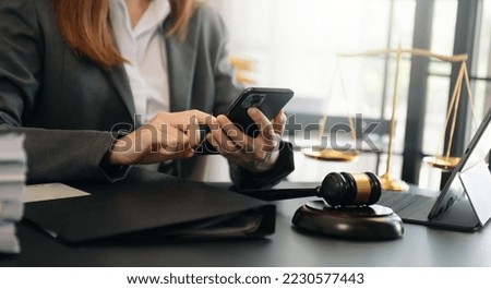 justice and law concept.Male judge in a courtroom  the gavel, working with smart phone and laptop and digital tablet computer on black table 