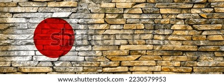 Flag of Japan. Flag is painted on a stone wall. Stone background. Copy space. Textured creative background