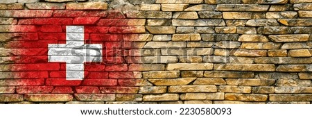 Flag of Switzerland. Flag is painted on a stone wall. Stone background. Copy space. Textured creative background