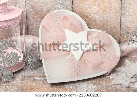 Colorful candle and colored candles of various shapes with a Christmas background on a wooden background and snow