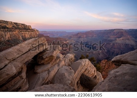 Rocky Outcropping Along The South Kaibab Trail As Sunrise breaks over the Grand Canyon