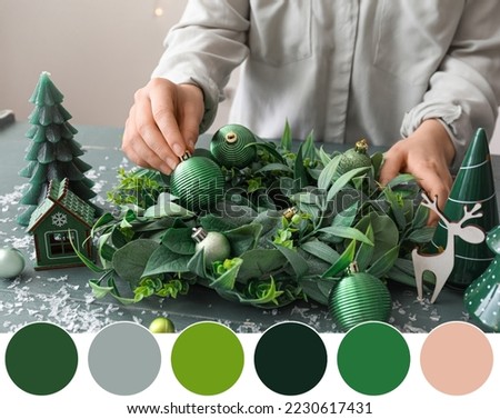 Woman making stylish Christmas wreath at table, closeup. Different color patterns